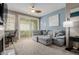 Comfortable living room features a sectional sofa, ceiling fan, and access to outdoor space at 11375 E Sahuaro Dr # 2015, Scottsdale, AZ 85259