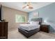 Cozy main bedroom featuring a tufted headboard, neutral colors, and a ceiling fan at 11375 E Sahuaro Dr # 2015, Scottsdale, AZ 85259