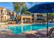 Community pool featuring comfortable lounge chairs, shade umbrellas, and a charming gazebo at 11375 E Sahuaro Dr # 2015, Scottsdale, AZ 85259