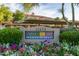 Community signage amidst colorful flowers and greenery at Frank's on Shea Condominiums at 11375 E Sahuaro Dr # 2015, Scottsdale, AZ 85259