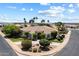 Stunning single-story home with manicured landscaping, mature palm trees, and circular driveway at 11403 E Caron St, Scottsdale, AZ 85259