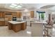 Spacious kitchen featuring an island with cooktop, breakfast bar, and lots of cabinet storage at 11403 E Caron St, Scottsdale, AZ 85259