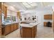 Bright kitchen featuring an island, breakfast bar, and ample counter space for cooking and entertaining at 11403 E Caron St, Scottsdale, AZ 85259