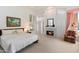 Serene main bedroom with fireplace, neutral carpet, ensuite bathroom, and access to backyard at 11403 E Caron St, Scottsdale, AZ 85259