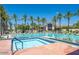 Resort-style pool and spa with tiled accents, palm trees, lounge seating, and lush landscaping offer a relaxing oasis at 11403 E Caron St, Scottsdale, AZ 85259