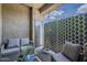 Cozy balcony featuring stylish seating, plants, and a decorative privacy screen at 11640 N Tatum Blvd # 2013, Phoenix, AZ 85028