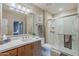 Elegant bathroom with a marble walk-in shower, wood cabinets, and modern fixtures at 11640 N Tatum Blvd # 2013, Phoenix, AZ 85028