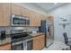 Modern kitchen featuring stainless steel appliances, granite countertops, and wood cabinetry at 11640 N Tatum Blvd # 2013, Phoenix, AZ 85028