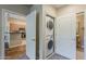 Convenient laundry closet with a stacked washer and dryer, located near the kitchen and bathroom at 11640 N Tatum Blvd # 2013, Phoenix, AZ 85028