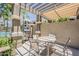 Outdoor grill and dining area under pergola with views of the community pool at 11640 N Tatum Blvd # 2013, Phoenix, AZ 85028
