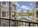 Scenic pool view from the balcony showcasing palm trees and complex amenities on a sunny day at 11640 N Tatum Blvd # 2013, Phoenix, AZ 85028