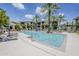 Beautiful community pool with lounge chairs and palm trees under a sunny blue sky at 11640 N Tatum Blvd # 2013, Phoenix, AZ 85028