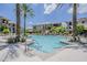 Resort-style pool with lush landscaping, palm trees, and lounge seating in a beautiful apartment complex at 11640 N Tatum Blvd # 2013, Phoenix, AZ 85028