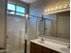 Bathroom features an updated double sink vanity, large mirror, and glass enclosed shower at 11921 W Madison St, Avondale, AZ 85323