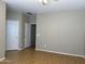 Bedroom with wood laminate flooring, neutral walls, and white doors for access and storage at 11921 W Madison St, Avondale, AZ 85323
