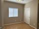 Cozy bedroom with hardwood floors, a window, a ceiling fan, and a closet with sliding doors at 11921 W Madison St, Avondale, AZ 85323