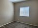 Bedroom with neutral walls, carpet flooring, and a bright window at 11921 W Madison St, Avondale, AZ 85323