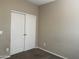 Bedroom features neutral walls, carpet flooring, and double door closet at 11921 W Madison St, Avondale, AZ 85323