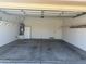 Spacious, clean garage with ample storage space, a water heater, and a side door for easy access at 11921 W Madison St, Avondale, AZ 85323