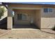 Covered patio area featuring access door and window at 11921 W Madison St, Avondale, AZ 85323