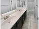 Bathroom vanity with double sinks, tile floors, and white countertops at 12211 W Prickly Pear Trl, Peoria, AZ 85383