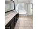 Well-lit bathroom featuring double sinks, granite countertops, tile flooring, a shower and a soaking tub at 12211 W Prickly Pear Trl, Peoria, AZ 85383