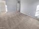 Neutral bedroom featuring carpet flooring, a large walk in closet, and a view of the sunny windows at 12211 W Prickly Pear Trl, Peoria, AZ 85383