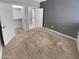 Spacious bedroom features neutral carpet, walk-in closet, and a light gray accent wall at 12211 W Prickly Pear Trl, Peoria, AZ 85383