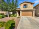 Charming two-story home featuring desert landscaping, a two car garage, and a covered front porch entrance at 12211 W Prickly Pear Trl, Peoria, AZ 85383