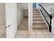 Hallway featuring stairway, storage space, and neutral tile flooring at 12211 W Prickly Pear Trl, Peoria, AZ 85383