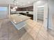 Modern kitchen with stainless steel appliances, granite countertops, and an oversized center island and a pantry at 12211 W Prickly Pear Trl, Peoria, AZ 85383