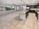 Open concept kitchen features a large island, stainless steel appliances and tile floors at 12211 W Prickly Pear Trl, Peoria, AZ 85383
