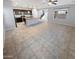 Open floor plan with tile flooring, a ceiling fan, neutral paint, and a kitchen island with bar stool seating at 12211 W Prickly Pear Trl, Peoria, AZ 85383