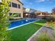 Backyard oasis with a refreshing pool, green turf, and lush landscaping at 12211 W Prickly Pear Trl, Peoria, AZ 85383