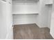 A well-organized walk-in closet with built-in shelves and carpeted flooring at 12211 W Prickly Pear Trl, Peoria, AZ 85383