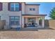 Backyard featuring a covered patio with stylish furniture, designed for relaxation and outdoor living at 1255 N Arizona Ave # 1251, Chandler, AZ 85225