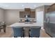 Well-lit kitchen with a large island, breakfast bar, and stainless steel appliances at 1255 N Arizona Ave # 1251, Chandler, AZ 85225