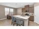 Well-lit kitchen with a large island, breakfast bar, and stainless steel appliances at 1255 N Arizona Ave # 1251, Chandler, AZ 85225