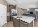 Modern kitchen featuring a central island with bar stools and stainless steel appliances at 1255 N Arizona Ave # 1251, Chandler, AZ 85225