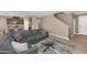 Comfortable living room featuring a sectional sofa, open to the kitchen, and a view of the staircase at 1255 N Arizona Ave # 1251, Chandler, AZ 85225