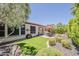 Beautiful backyard featuring a patio area, artificial grass and well-manicured landscaping for outdoor enjoyment at 12738 W Brookhart Way, Peoria, AZ 85383