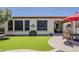 A beautiful backyard with artificial turf, patio dining set, and landscaped borders for relaxation and entertaining at 12738 W Brookhart Way, Peoria, AZ 85383