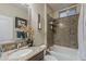 Stylish bathroom featuring a bathtub with stone-look surround, granite countertops, and elegant decorative accents at 12738 W Brookhart Way, Peoria, AZ 85383