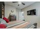 Inviting bedroom features neutral walls, ceiling fan, dresser, and comfortable bedding at 12738 W Brookhart Way, Peoria, AZ 85383