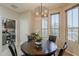 Cozy dining area features a round wood table, decorative light fixture, and views from the adjacent windows at 12738 W Brookhart Way, Peoria, AZ 85383