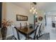 Stylish dining room with modern chandelier and easy access to the kitchen at 12738 W Brookhart Way, Peoria, AZ 85383