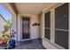 Covered front porch with beautiful flooring and desert decor at 12738 W Brookhart Way, Peoria, AZ 85383