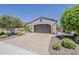 Attached two car garage with brick paved driveway and desert landscaping at 12738 W Brookhart Way, Peoria, AZ 85383