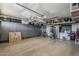 Clean, spacious garage with custom cabinetry and overhead storage racks for organized storage solutions at 12738 W Brookhart Way, Peoria, AZ 85383