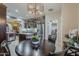 Open kitchen and dining area featuring stainless steel appliances, dark wood cabinetry, and pendant lighting at 12738 W Brookhart Way, Peoria, AZ 85383